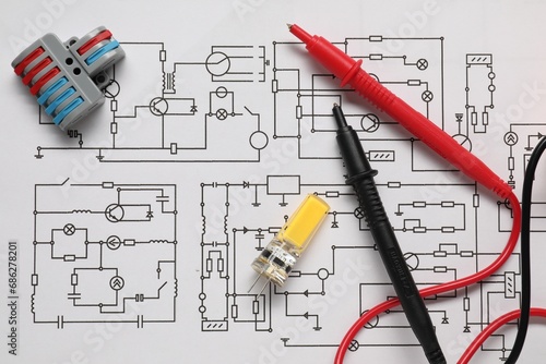 Different electrician's equipment on wiring diagram, flat lay