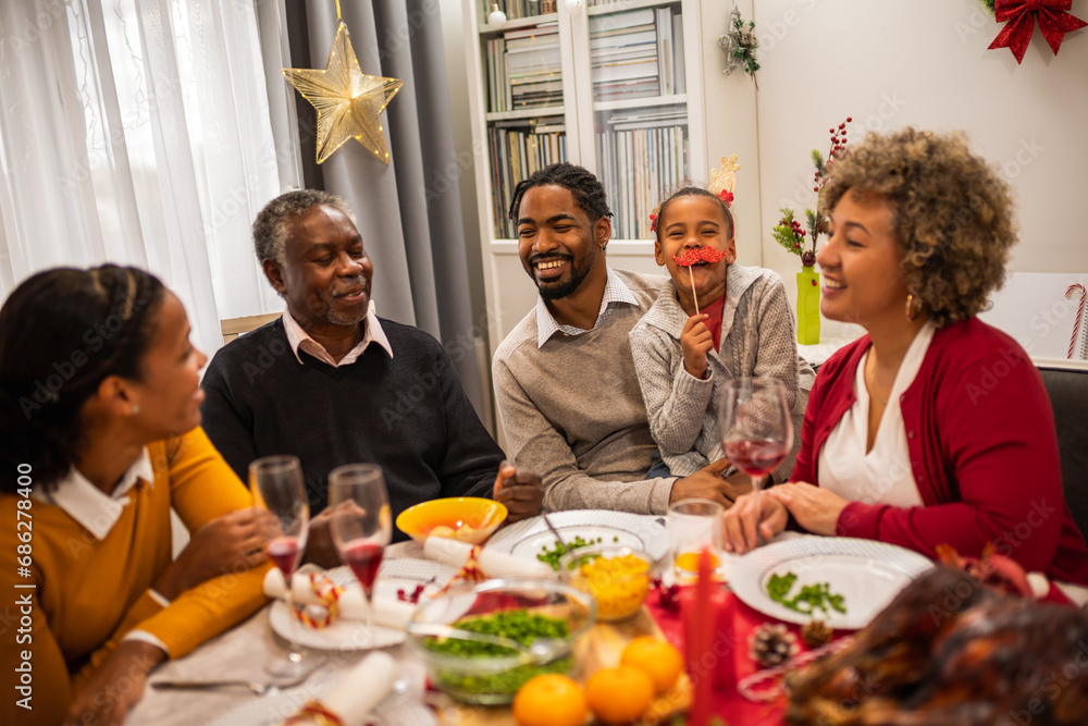 Family having fun on Christmas Eve by the table. Family having fun on Christmas Eve by the table.