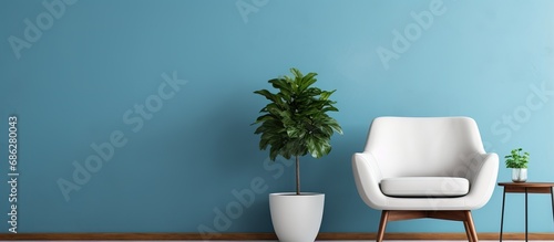 Trendy living room with blue and white walls potted plant and stylish chair photo