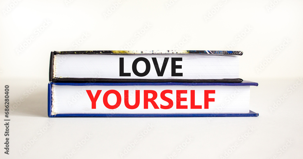 Love yourself symbol. Concept words Love yourself on beautiful books. Beautiful white table white background. Psychology love yourself concept. Copy space.