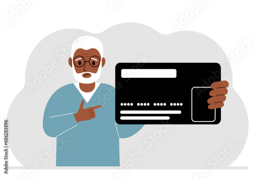A man holds a large plastic credit card in his hand.