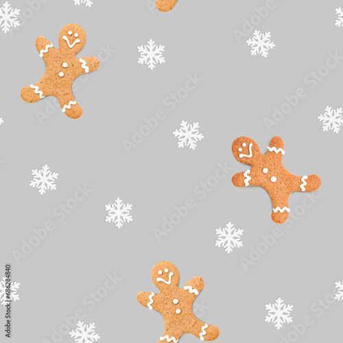 Christmas seamless pattern of gingerbread men and snowflakes on a gray background