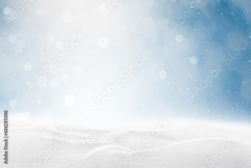 Sunlit snowdrifts and falling snow on a defocus blue background