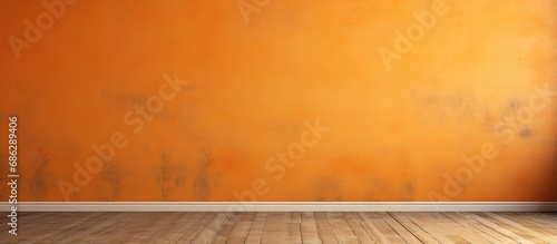 Orange cement wall and wooden floor in an empty room background
