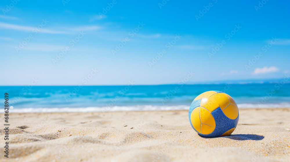 Naklejka premium Volleyball on a sunny beach with clear blue skies in the background.