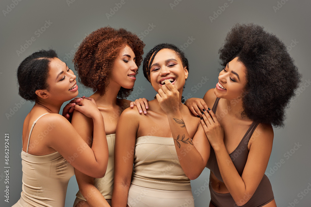 Obraz premium beautiful cheerful african american women in underwear having great time together, fashion concept