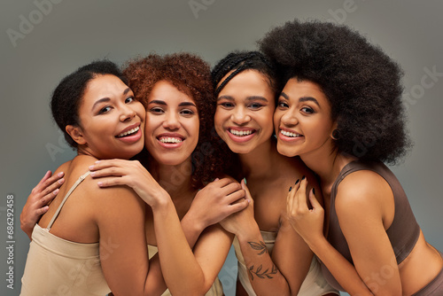 beautiful cheerful african american women in underwear having great time together, fashion concept