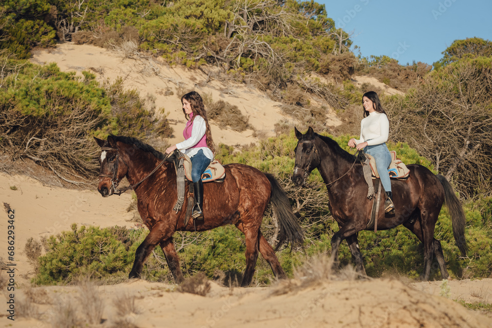 Group of female friends riding horses in nature Group of female friends riding horses in nature
