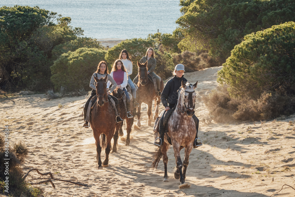 Group of female friends riding horses in nature