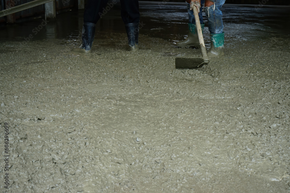 worker with adjusting cement floors worker with adjusting cement floors