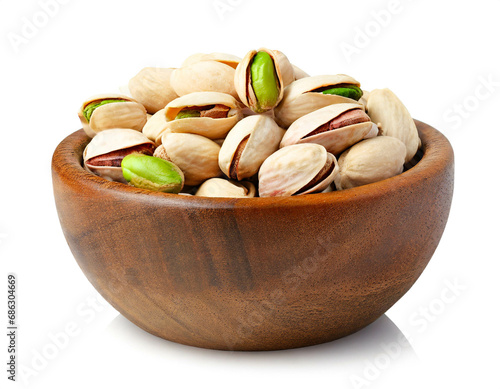 Wooden bowl with pistachios isolated on white background, cut out