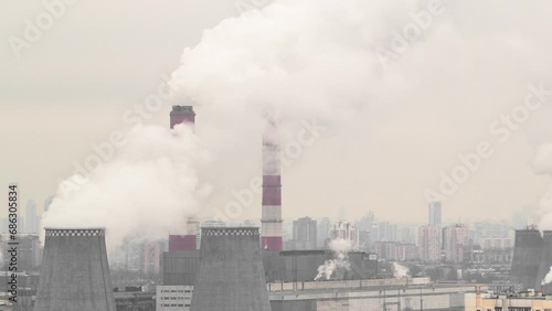 Aerial Winter Timelapse: Moscow's Urban Development in Progress on Ozernaya Street. Smoking pipes of power station and ongoing development and growth of Moscow's urban landscape during the winter day photo