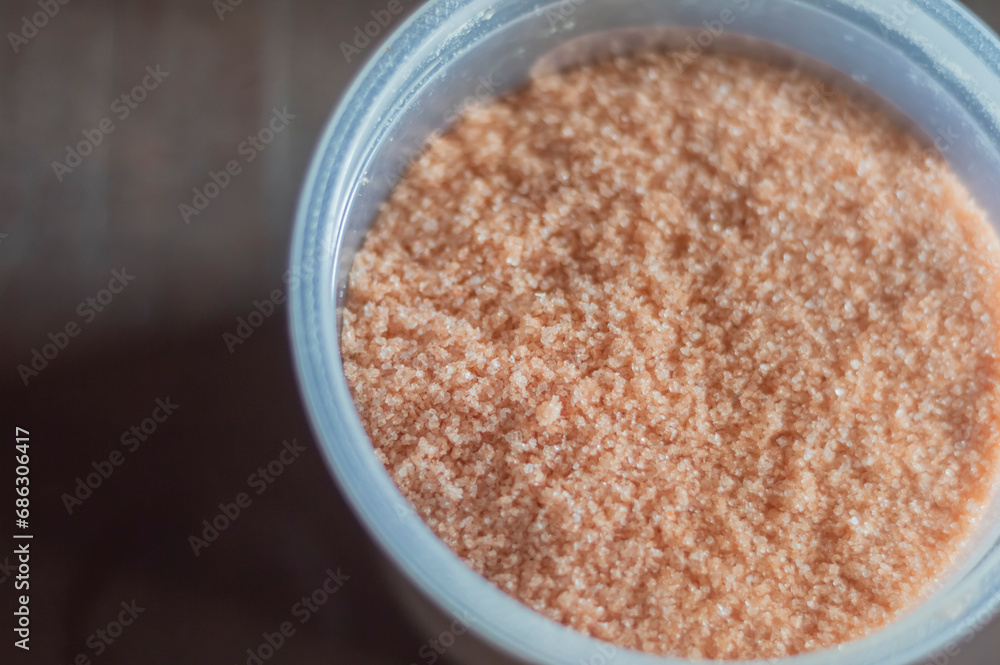 Himalayan salt on a wooden board with natural light, red salt Himalayan salt on a wooden board with natural light, red salt