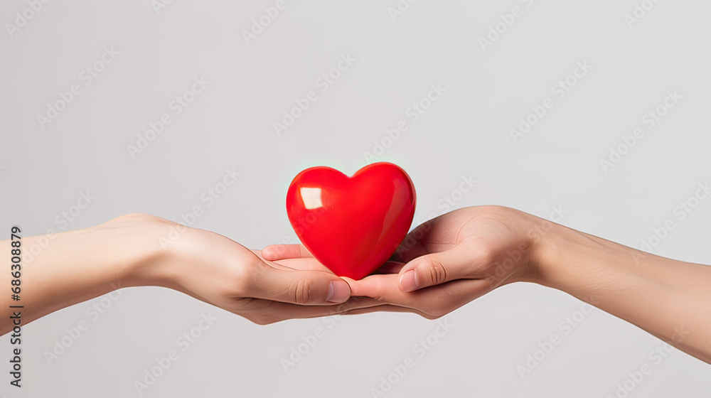 Fototapeta premium A man gives a woman a red heart on a white background