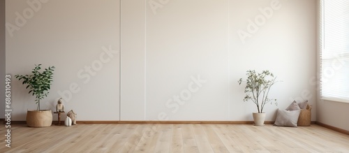Empty bedroom with white walls laminate flooring and fitted wardrobe