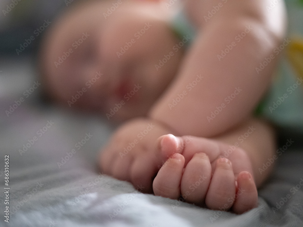 baby sleeping peacefully with selective focus on hand baby sleeping peacefully with selective focus on hand