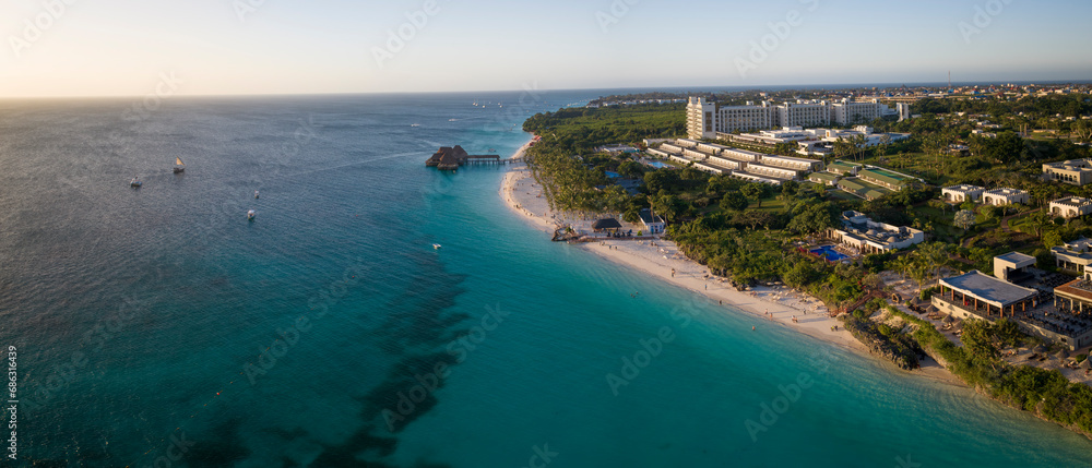 Aerial shot of Zanzibar beach where tourists and locals mix together of colors and joy, concept of summer vacation, aerial view of Kendwa beach, Tanzania