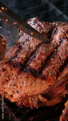 cooking steaks on the fire in real Close-up view of juicy cooked slices of meat with flames. original dish recipe. Professional cooking, food recipe, cooking. Horizontal . Top view. photo
