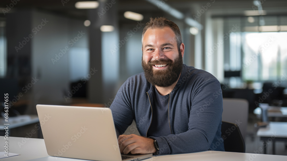 Middle aged man working on a laptop in his modern office Middle aged man working on a laptop in his modern office