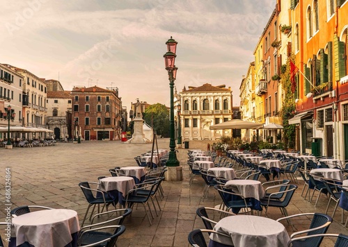Campo santo stefano typical place in venice italy architecture with restaurant tables out photo
