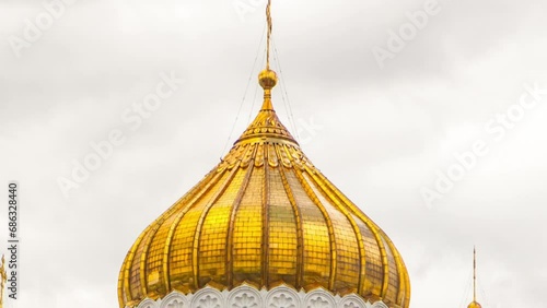 Majestic orthodox Cathedral of Christ Saviour with clouds on a blue sky. It is tallest Orthodox church in world with golden dome. Timelapse hyperlapse from waterfront, Russia