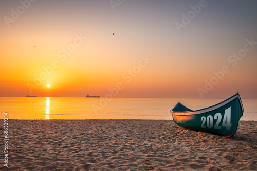2024 New year concept Fishing Boat on Varna beach shore on sunrise #686329284