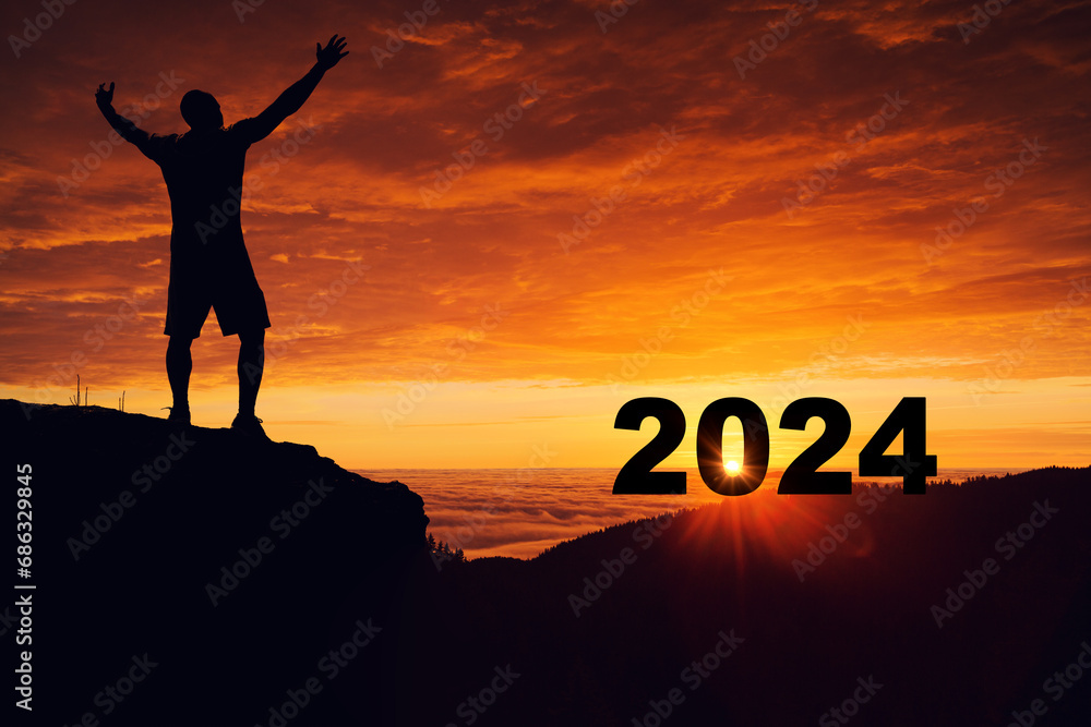 Man hiker on the mountain top watching sunrise horizon of new year 2024, freedom, living in nature concept Man hiker on the mountain top watching sunrise horizon of new year 2024, freedom, living in nature concept