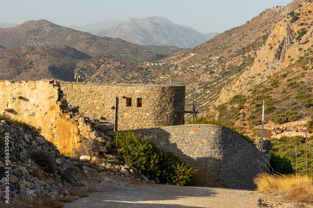 The impressive ruins of the Vrouhas windmills on a beautiful sunny day.  Crete, Greece.