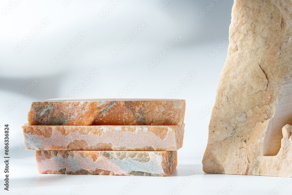 Piece of granite stone on white background with shadows Piece of granite stone on white background with shadows