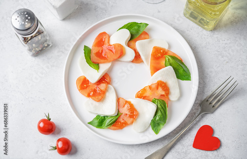 Caprese salad with tomatoes and mozzarella in the shape of hearts for Valentine's Day