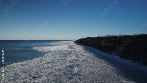 North nature landscape with a lot of ice floes. Aerial top view of coast line in winter. Gulf of Finland. Baltic 
