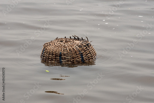 Hancrafted basket in a river photo