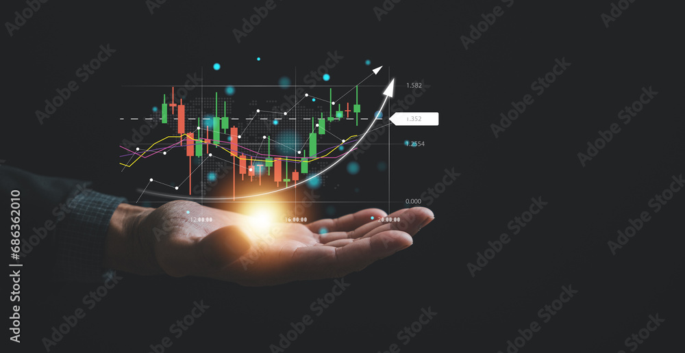 Navigating the complexities of the stock market, a trader or investor relies on a palm-sized device, examining candlestick charts and employing cutting-edge tools to optimize their trading strategies. - obrazy, fototapety, plakaty 