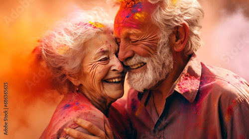 An elderly couple, a man and a woman, at the celebration of the Holi festival. Traditions of the Holya Festival. A bright colorful portrait of a married couple. 