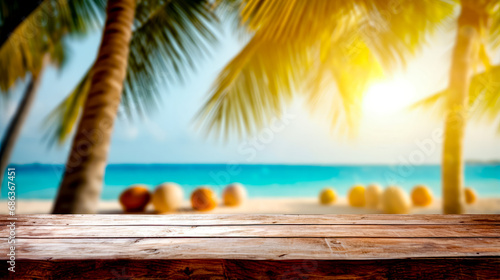 Wooden table top on beach with palm tree in the background.