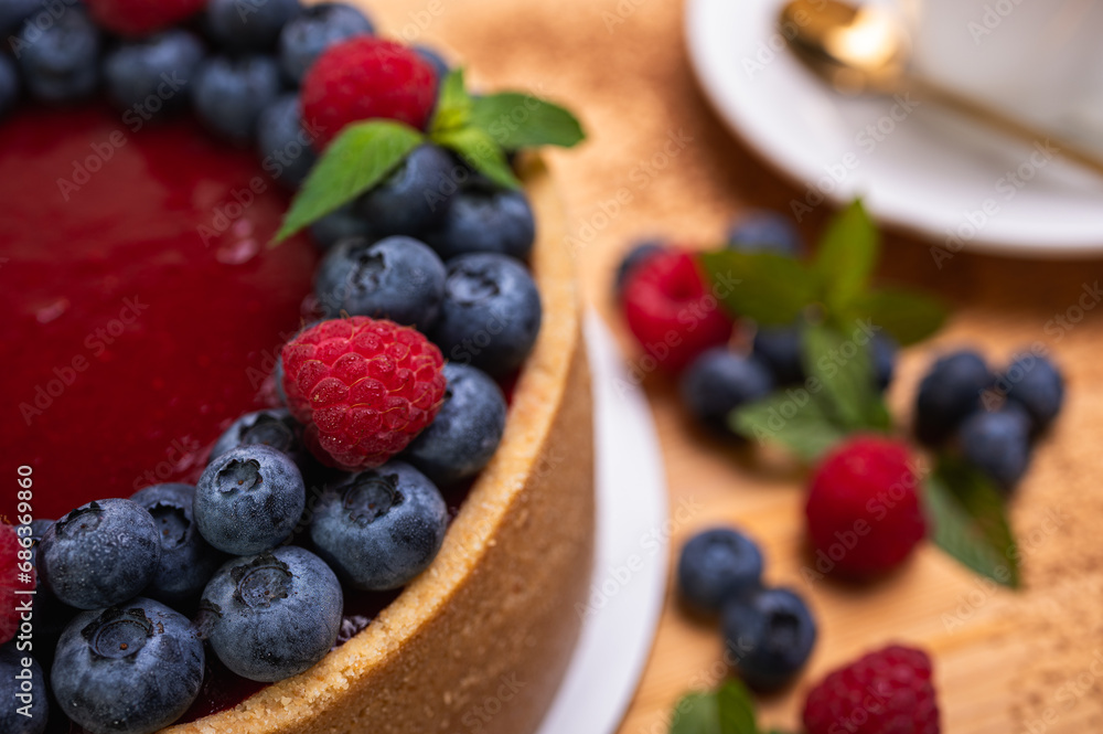 close-up of cheesecake with cream filling, decorated with fresh berries, blueberries and raspberries, festive New Year's cake, Christmas close-up of cheesecake with cream filling, decorated with fresh berries, blueberries and raspberries, festive New Year's cake, Christmas