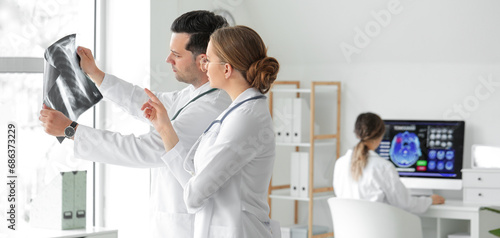 Doctors studying x-ray imag...
