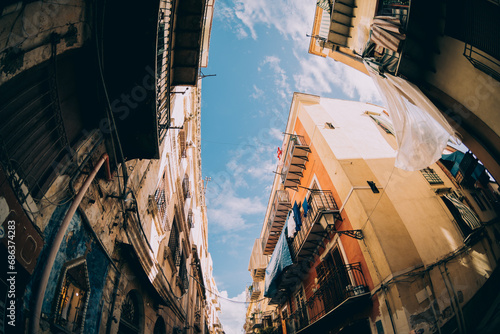 Fototapeta Naklejka Na Ścianę i Meble -  Street view in Palermo. Traditional old houses against blue sunny sky.
