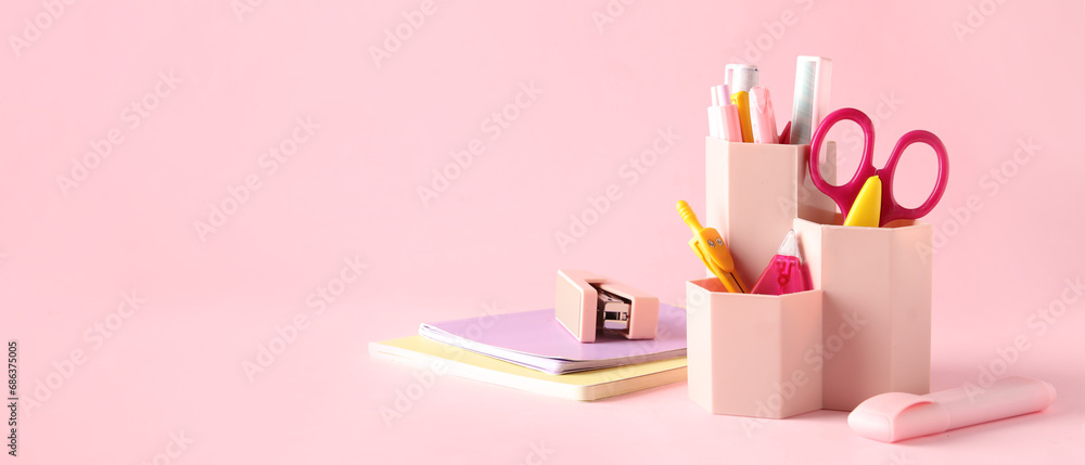 Holder with different stationery on pink background with space for text Holder with different stationery on pink background with space for text