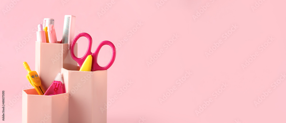 Holder with different stationery on pink background with space for text Holder with different stationery on pink background with space for text