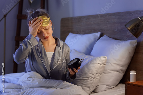 Sleepy young woman with ala...