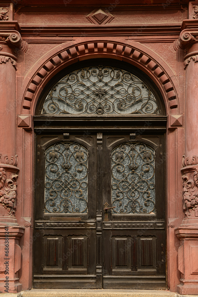 Old wooden door with decorative elements in city