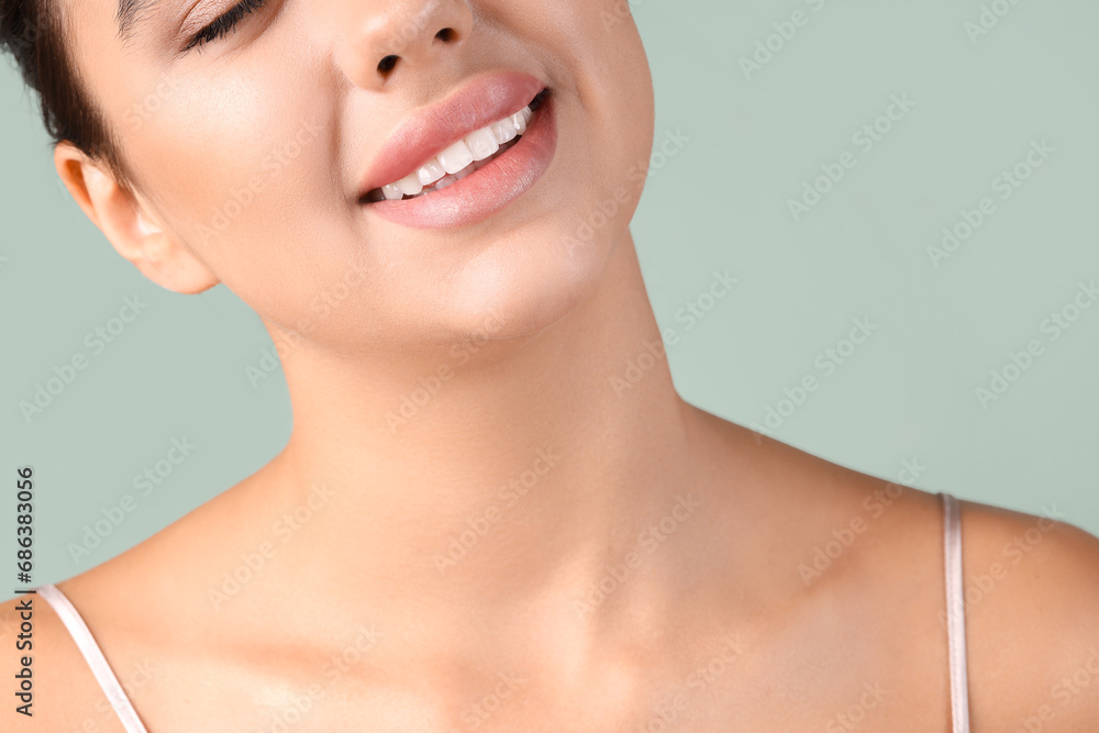 Obraz premium Young woman with beautiful lips on green background, closeup