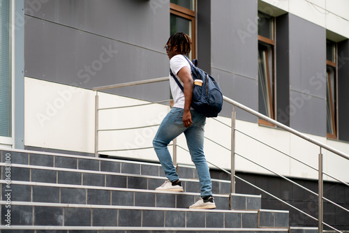 young african american stepping on the stairs in the urban cityscape