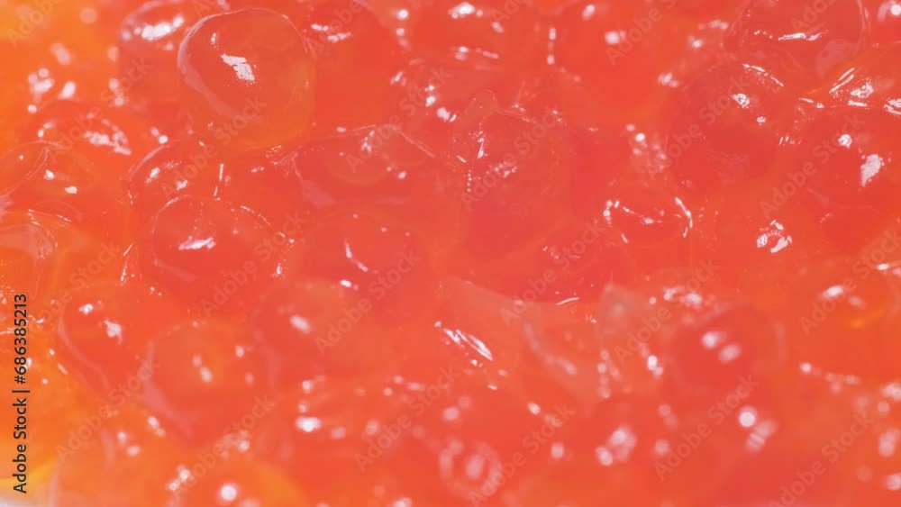 Macro video of fresh red caviar spinning in a circle. Caviar background. Fish delicacy Macro video of fresh red caviar spinning in a circle. Caviar background. Fish delicacy