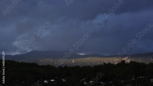 Beautiful sunshine above the mountains of Njivice, Croatia. Continuously changing lights and shadows. Huge wind on the day after Storm Ciarán smashed into Krk Island. Extreme weather conditions. photo