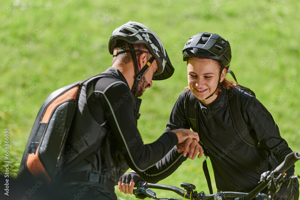 Fototapeta premium A sweet couple, equipped with bicycles and engrossed in coordinating their journey, checks their GPS mobile and watches while planning scenic routes in the park, seamlessly blending technology and