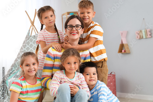 Quadro su tela Little children with nursery teacher in kindergarten