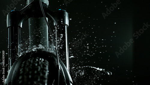 Mountain Bike Suspension Fork on Dark Background with Water Splash, Studio Shot