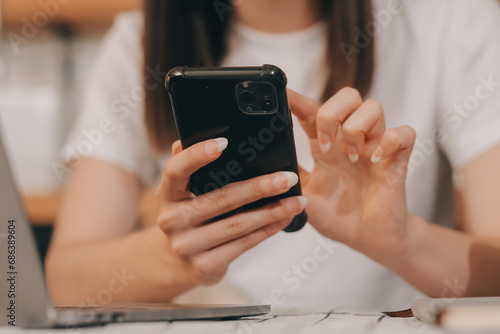 Cropped photo of Freelancer business Asian woman holding coffee cup and at doing planning analyzing the financial report, business plan investment, finance analysis the workplace.